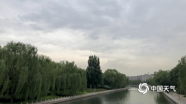 阵雨遇上北京早高峰 市民打伞出行